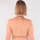Blonde woman in a chain harness top back view