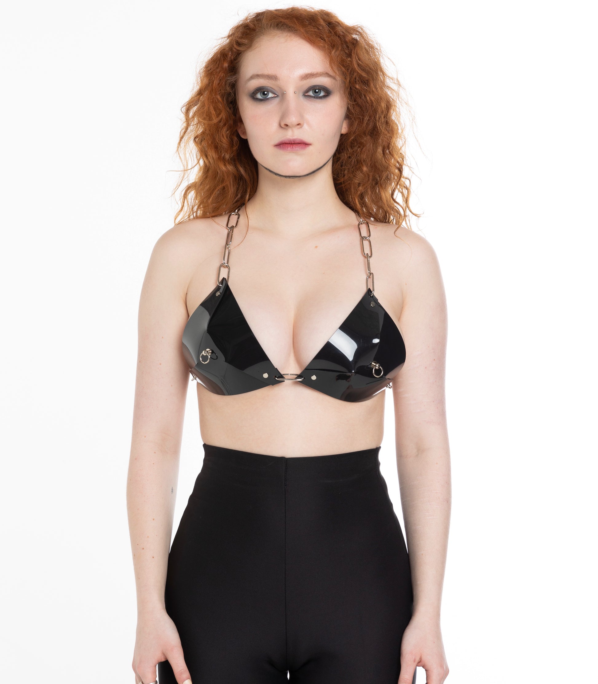 Woman in black PVC bra with chain elements