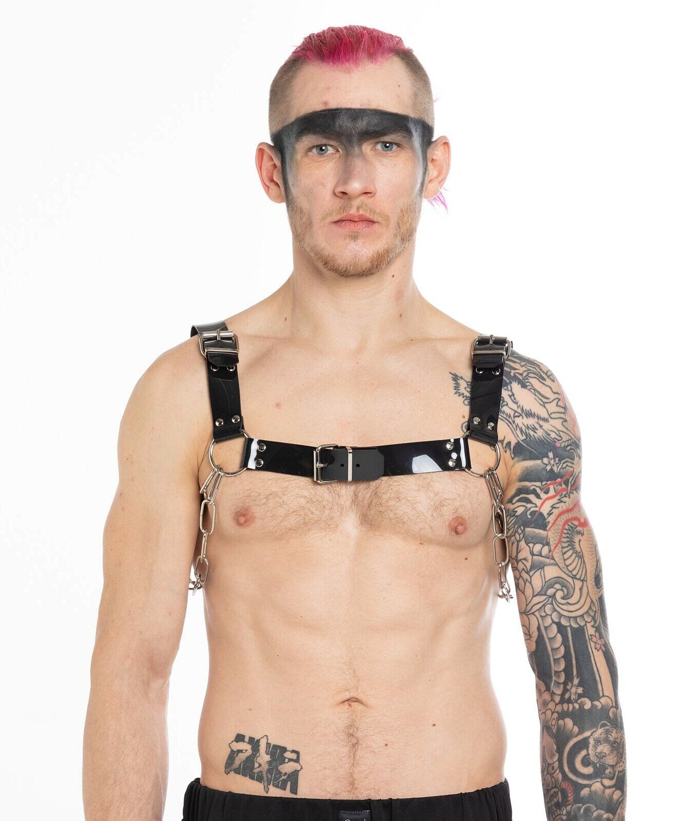 Tattooed Berlin raver with a PVC chest harness